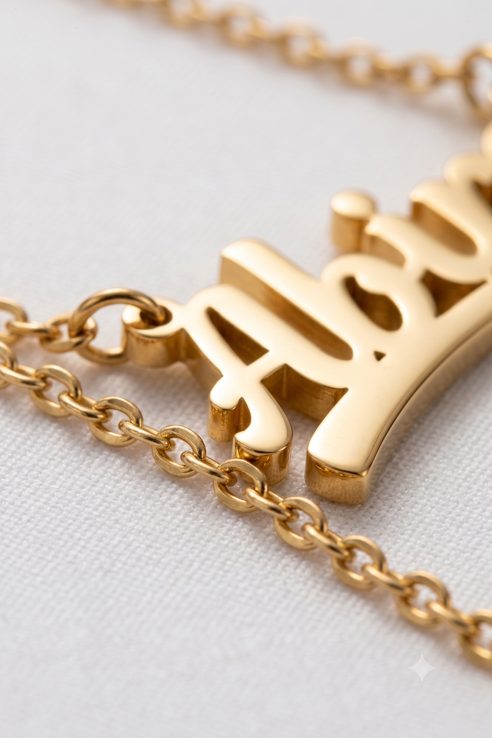 Close-up of bold name pendant lettering