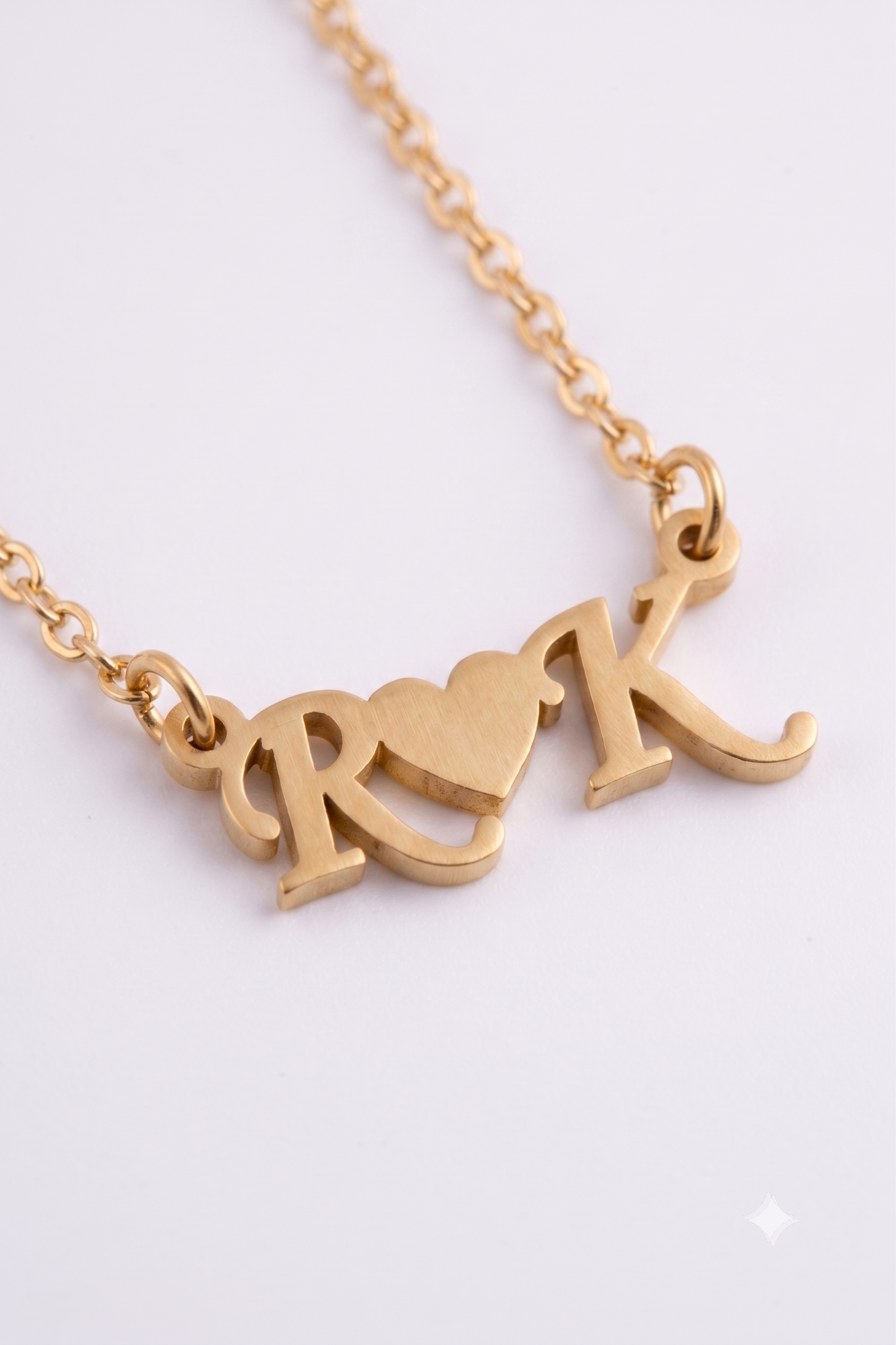 Two initials with heart pendant close-up