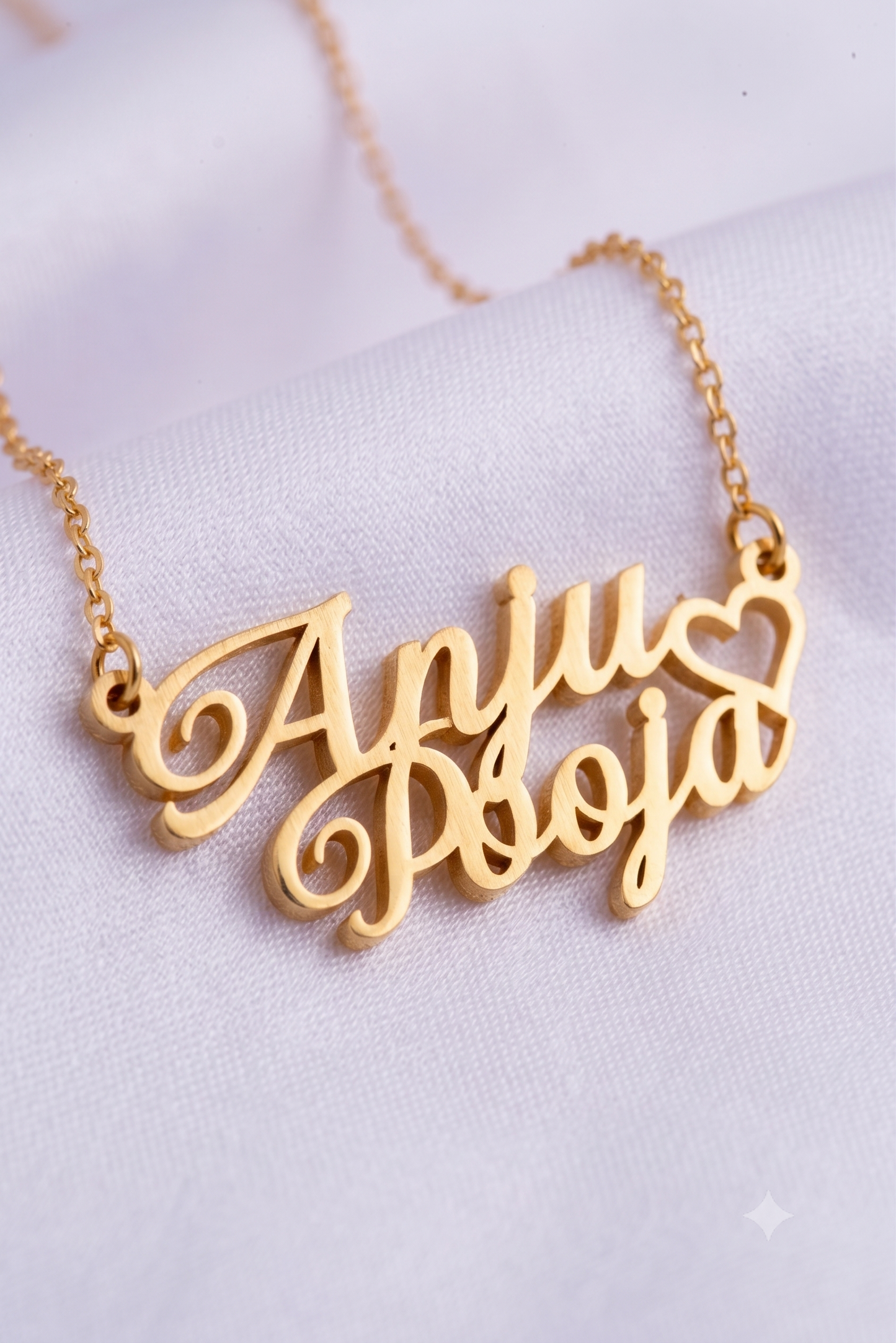 Close-up of double name pendant with heart