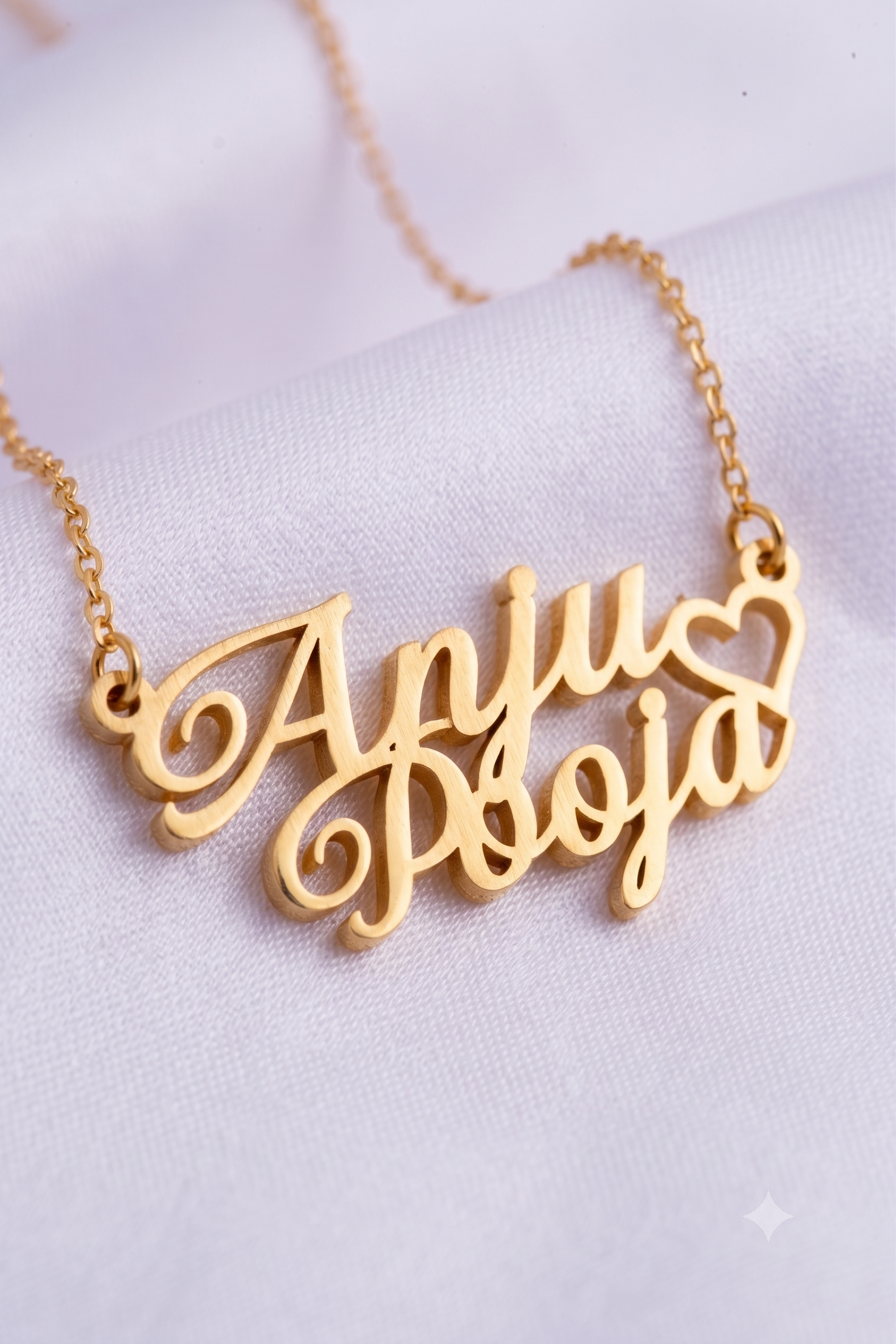Close-up of double name pendant with heart