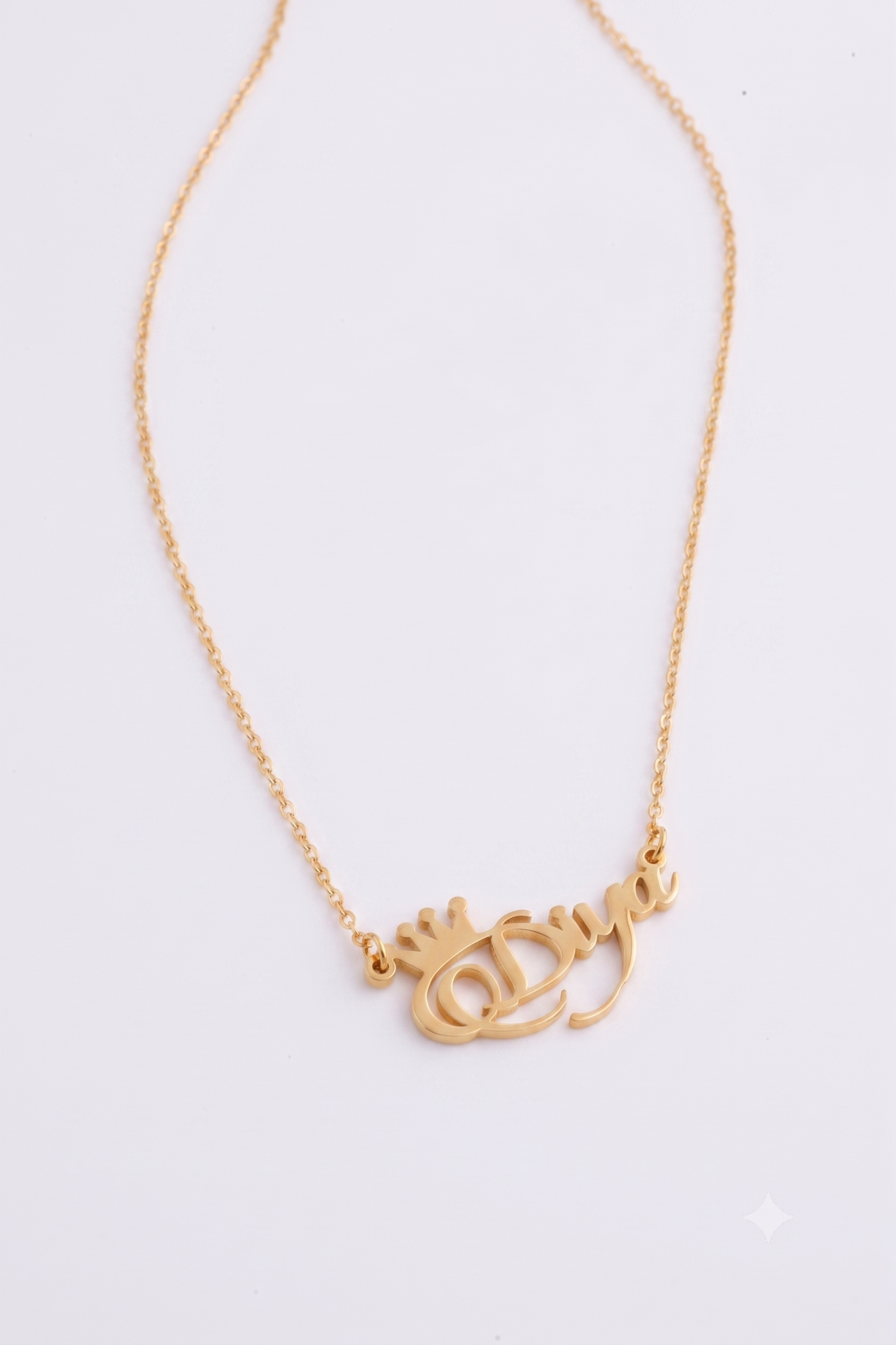 Personalised gold name necklace flat lay