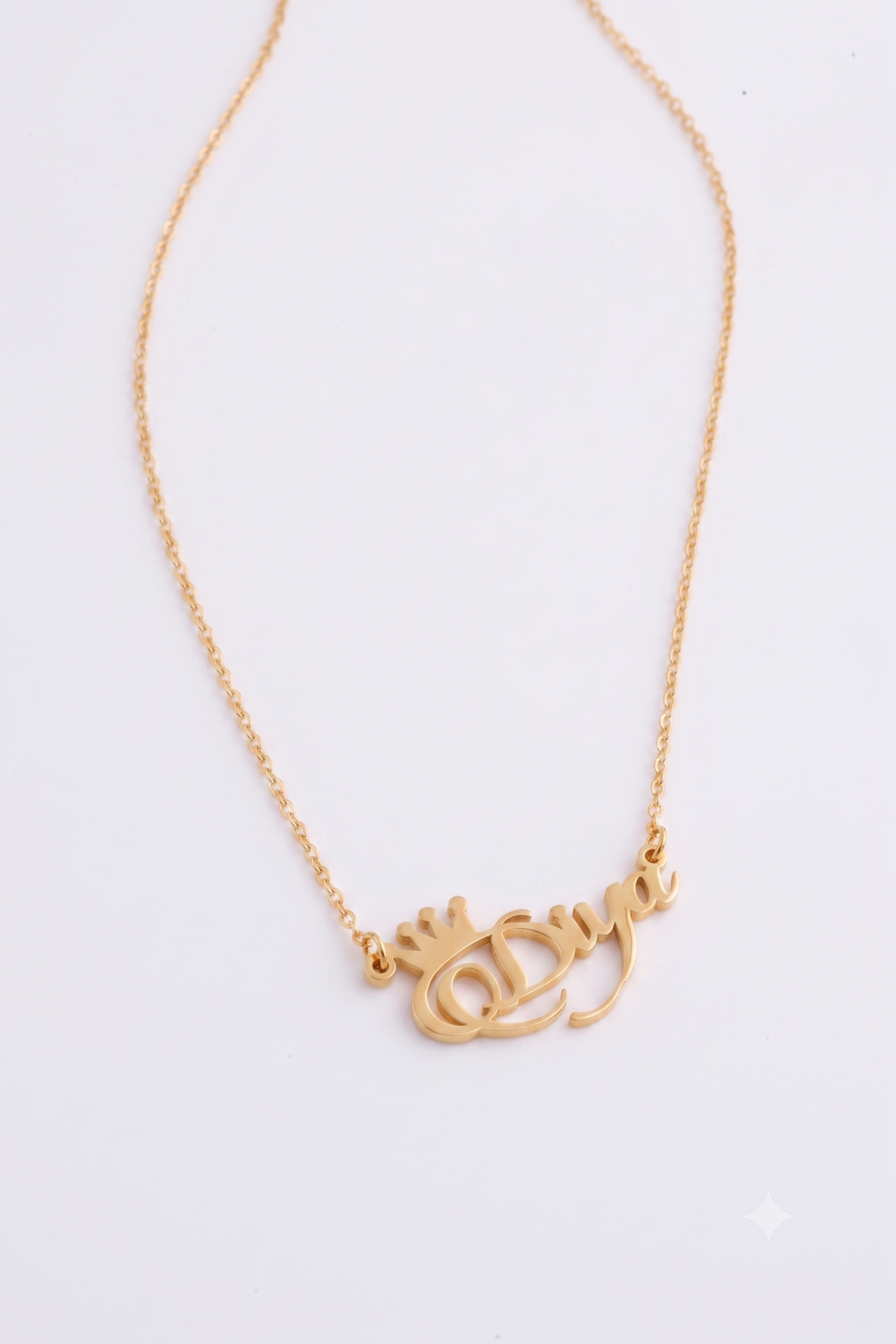 Personalised gold name necklace flat lay