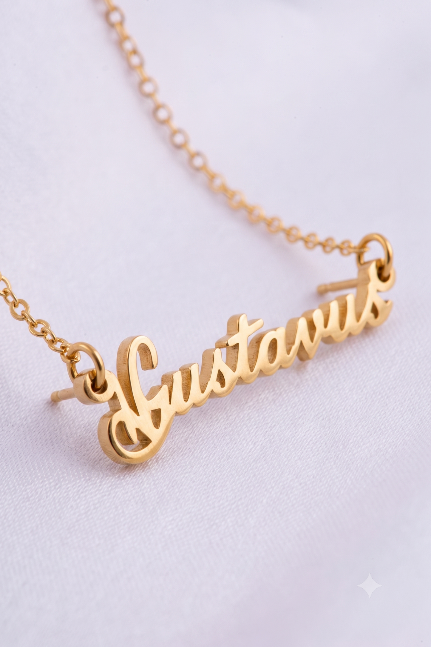 Close-up of cursive script name pendant