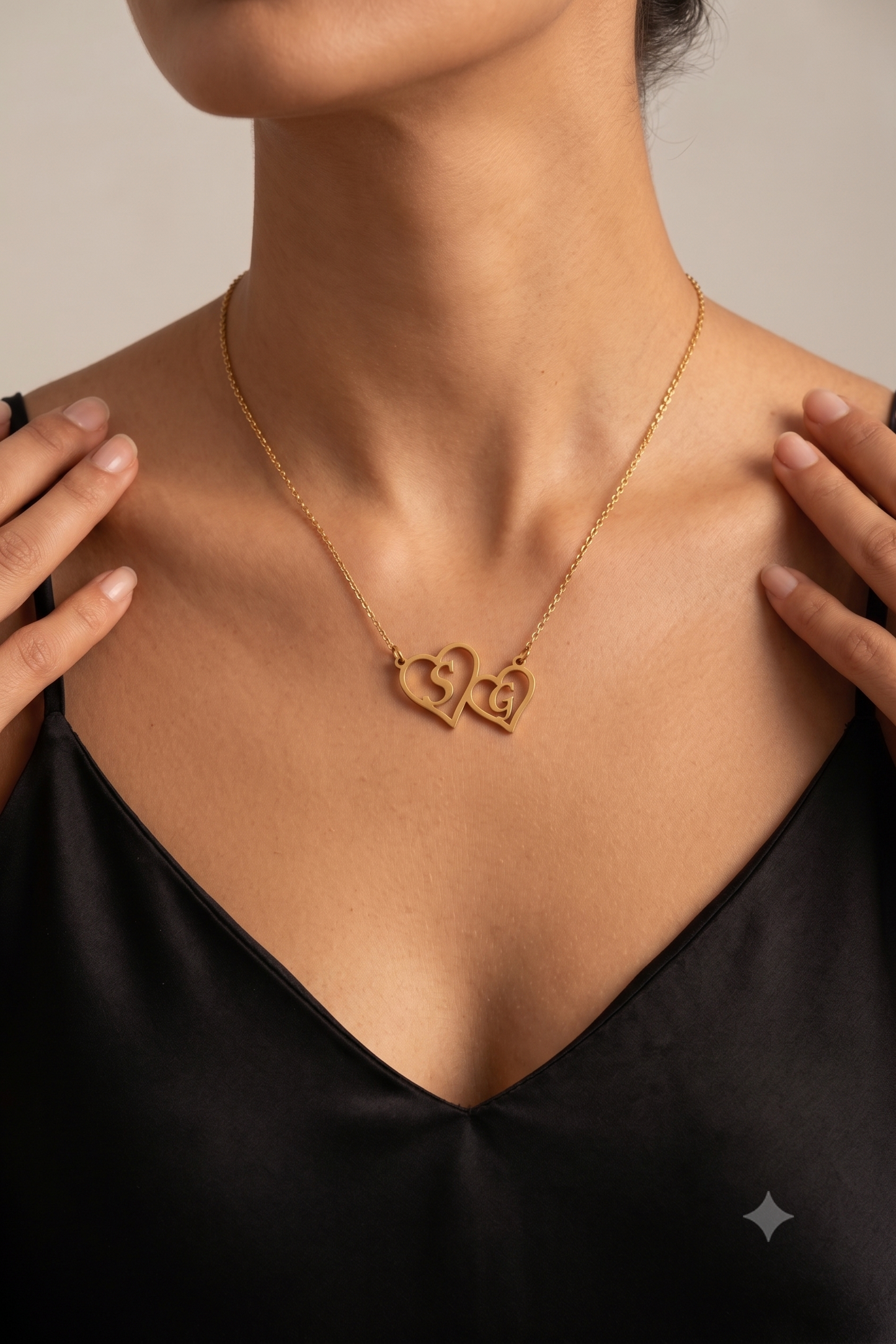Twin hearts initials necklace worn on model